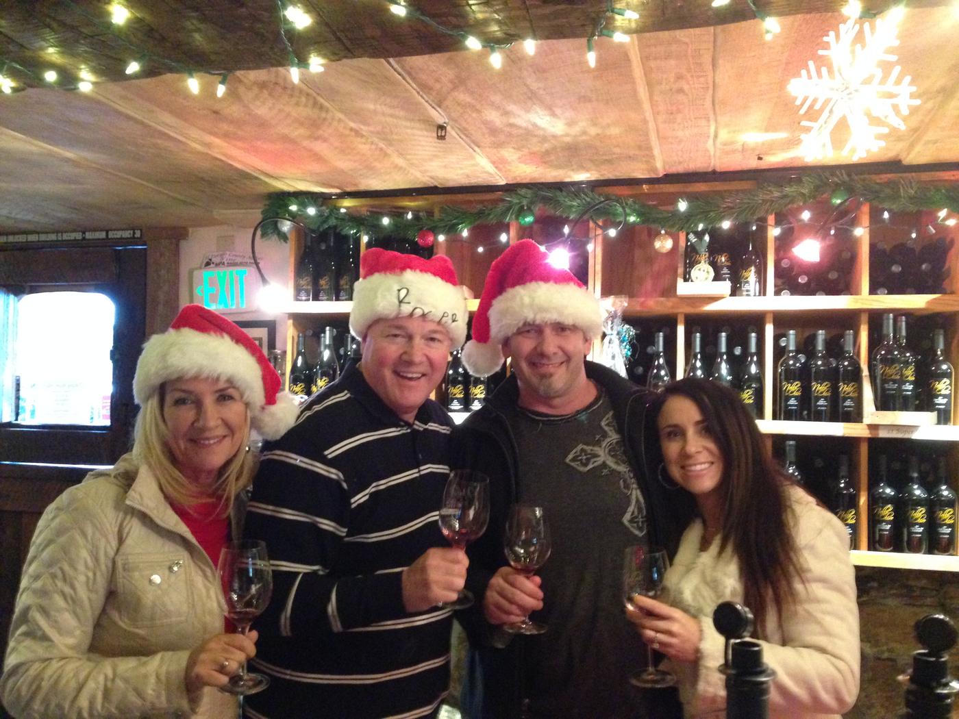 Members in Santa hats toasting under the snowflakes