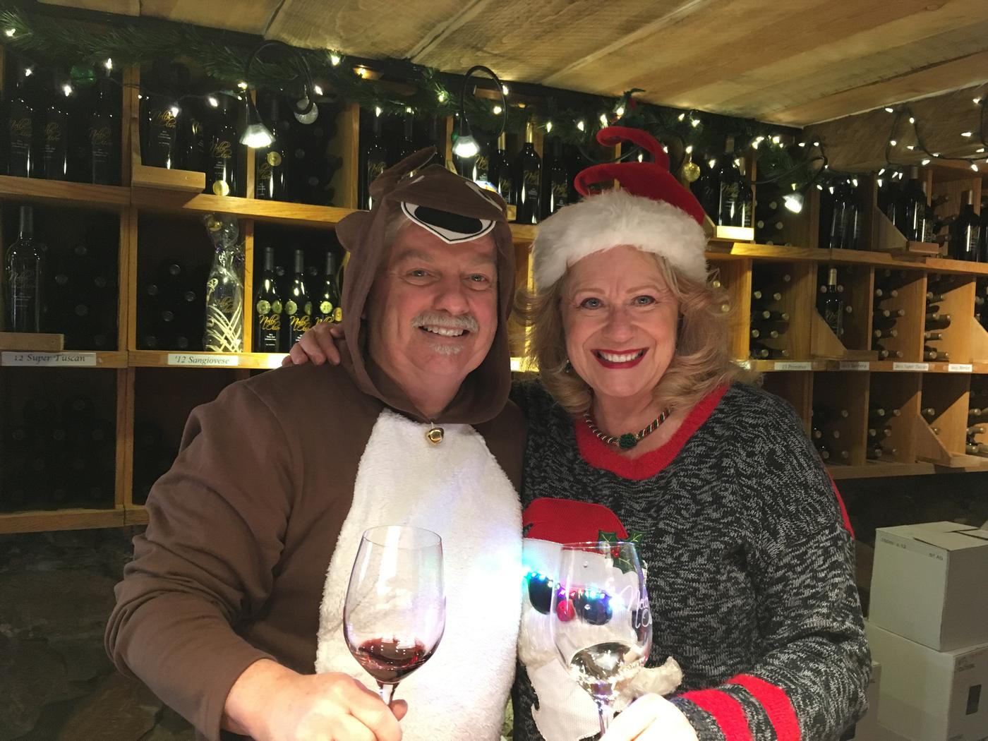 Two members laughing in Christmas costume